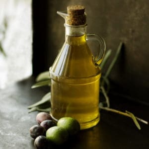 photo of bottle of olive oil with olives representing biancolilla extra virgin olive oil