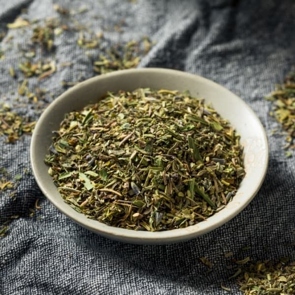 photo of mixed herbs in bowl representing herbes de provence olive oil