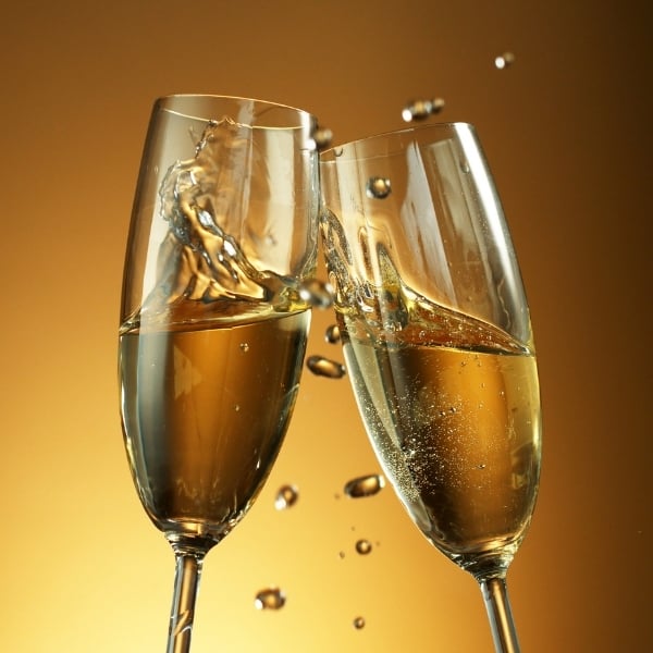 photo of two glasses of champagne clinking together representing champagne vinegar