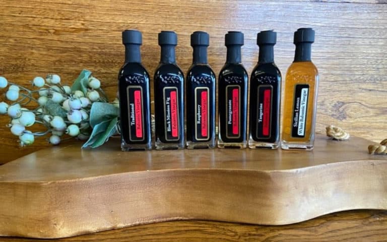 OV Harvest balsamic vinegar sampler on wood background