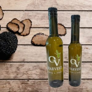Black truffles and OV Harvest oil bottles representing Black Truffle Oil