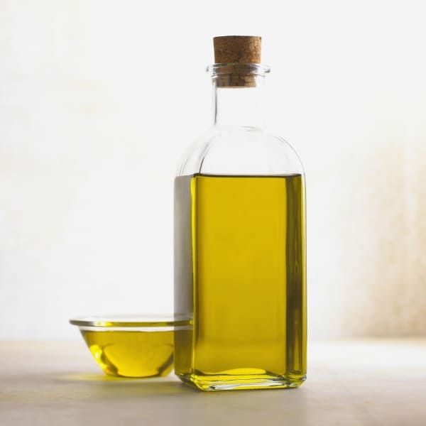 Bottle and dish of Olive Oil representing OV Harvest Estate Reserve Extra Virgin Olive Oil
