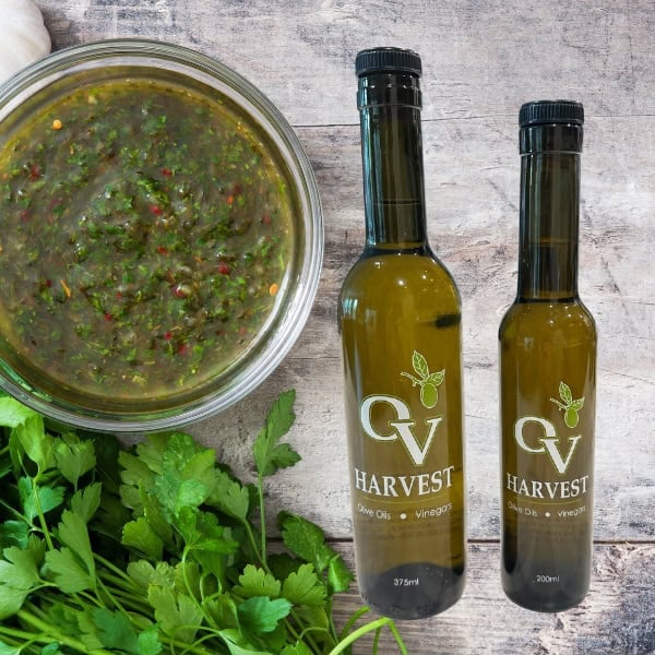 Bowl of Chimichurri and OV Harvest Olive Oil Bottles representing Chimichurri Verde Olive Oil