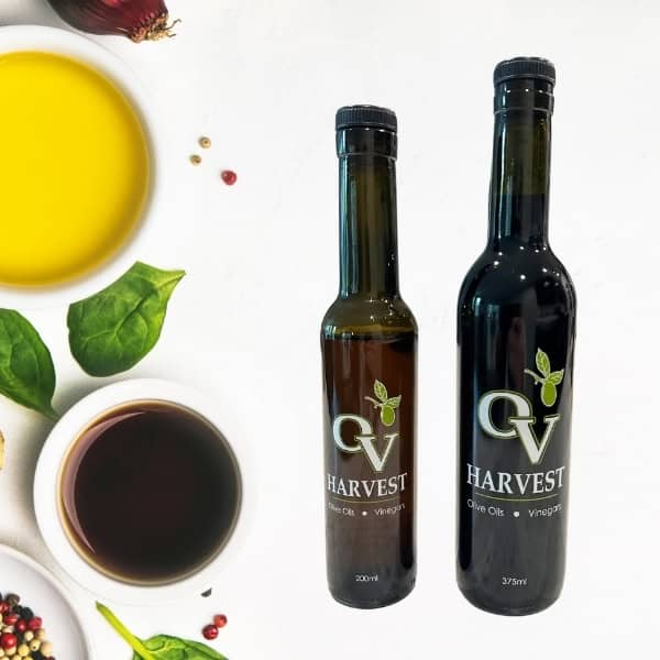 Bowl of balsamic vinegar, bowl of olive oil, bowl of peppercorns and OV Harvest balsamic vinegar bottles representing Traditional Style Balsamic Vinegar