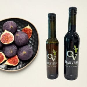 Bowl of figs and OV Harvest balsamic vinegar bottles representing Fig Balsamic Vinegar
