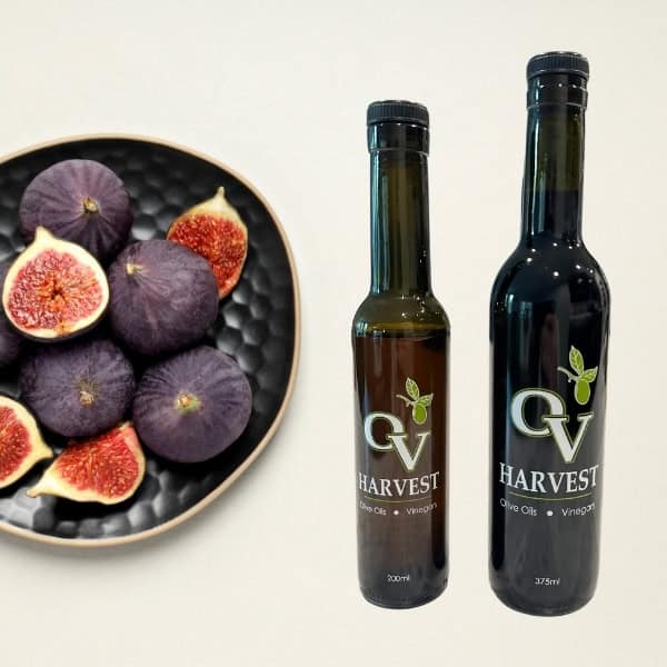 Bowl of figs and OV Harvest balsamic vinegar bottles representing Fig Balsamic Vinegar