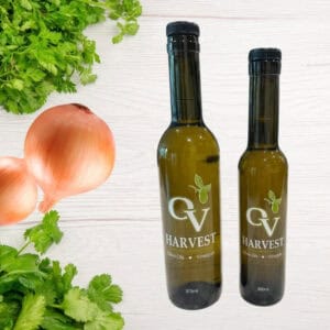 Cilantro, onions and OV Harvest olive oil bottles representing Cilantro & Roasted Onion Olive Oil