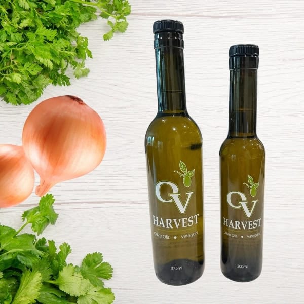 Cilantro, onions and OV Harvest olive oil bottles representing Cilantro & Roasted Onion Olive Oil