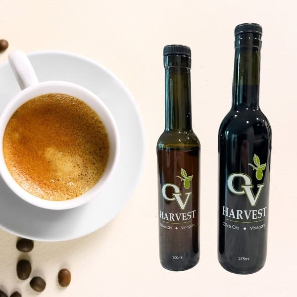Cup of espresso, coffee beans and OV Harvest balsamic vinegar bottles representing Espresso Balsamic Vinegar