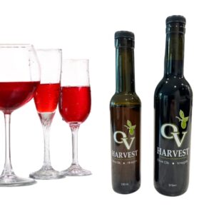 Glasses of wine and OV Harvest balsamic vinegar bottles representing Lambrusco Wine Vinegar