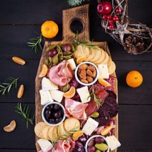 Holiday Charcuterie Board with meat, nuts, fruit and cheese