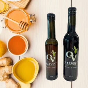 Honey, ginger root and OV Harvest balsamic vinegar bottles representing Honey-Ginger White Balsamic Vinegar