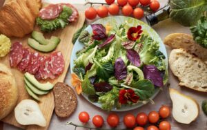 Top view mixed fresh type of greens, edible flowers and salad representing an Italian Salad.