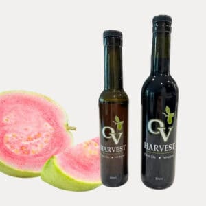 Pink guava slices and OV Harvest balsamic vinegar bottles representing Pink Guava Rosé Balsamic Vinegar